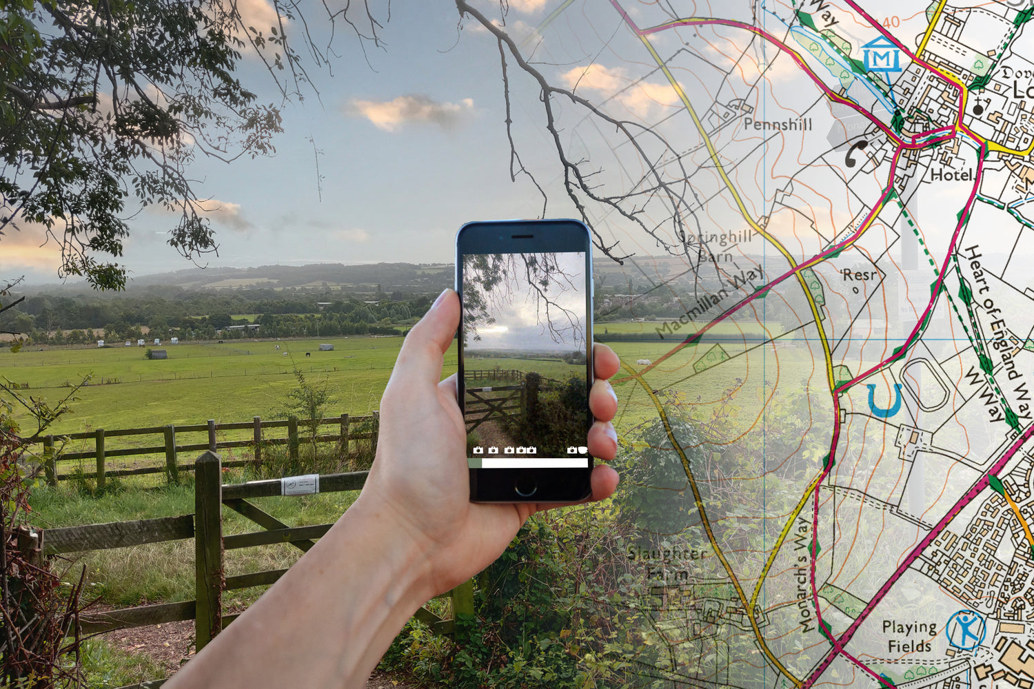 A man holding a phone with countryside in the background