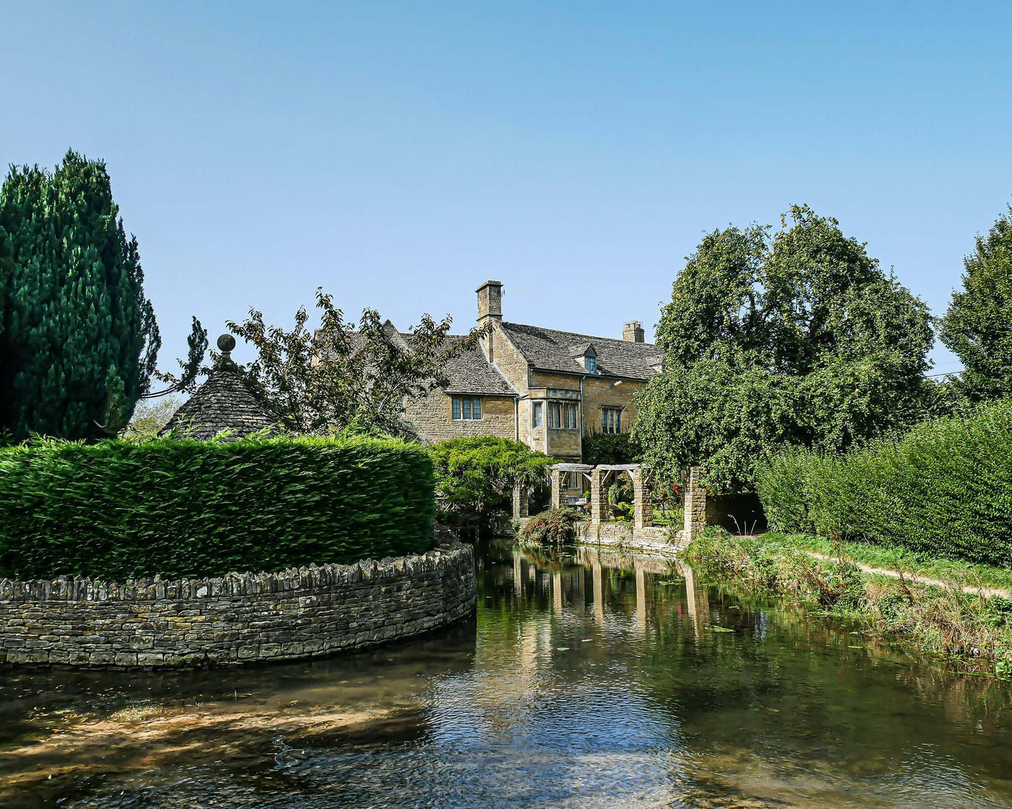 Old stone houses next to a stream